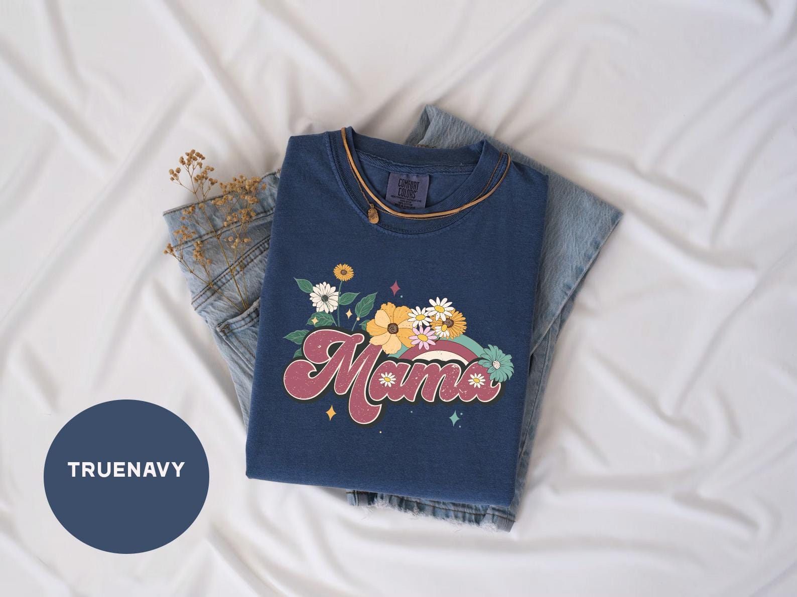 a blue t - shirt with the word mama written on it