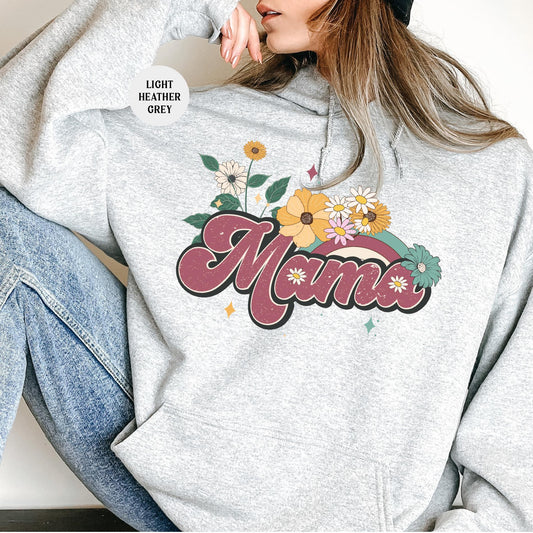 a woman sitting on the floor wearing a gray hoodie