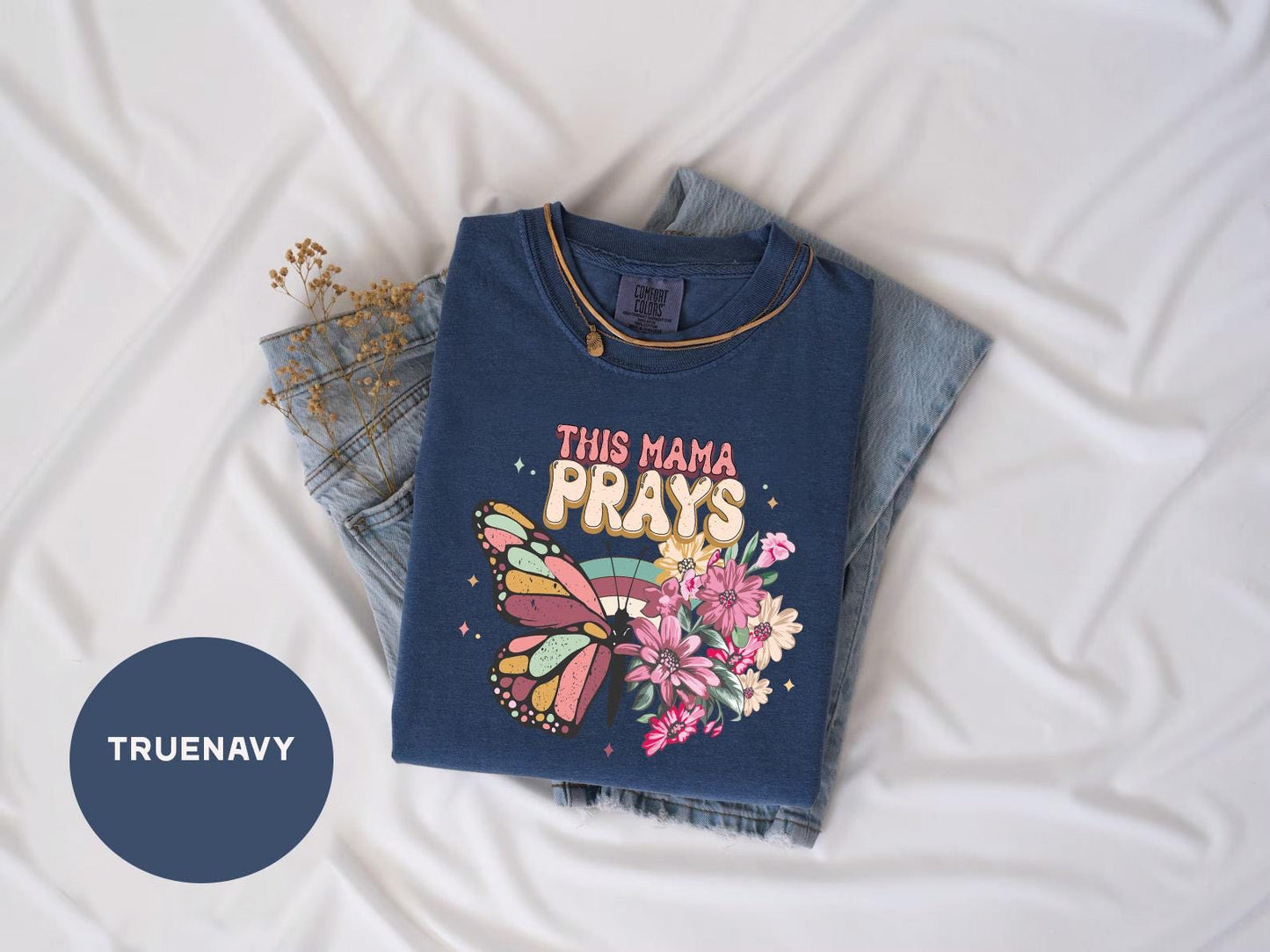 a t - shirt that says this mama prays on it