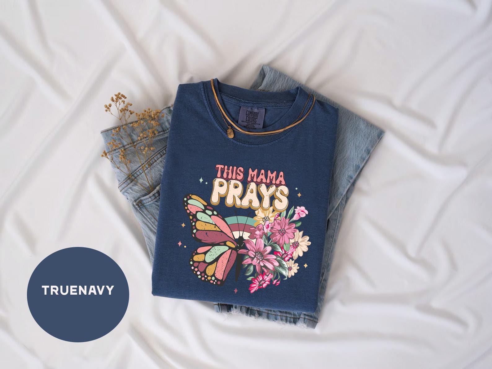 a t - shirt that says this mama prays on it