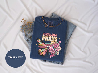 a t - shirt that says this mama prays on it