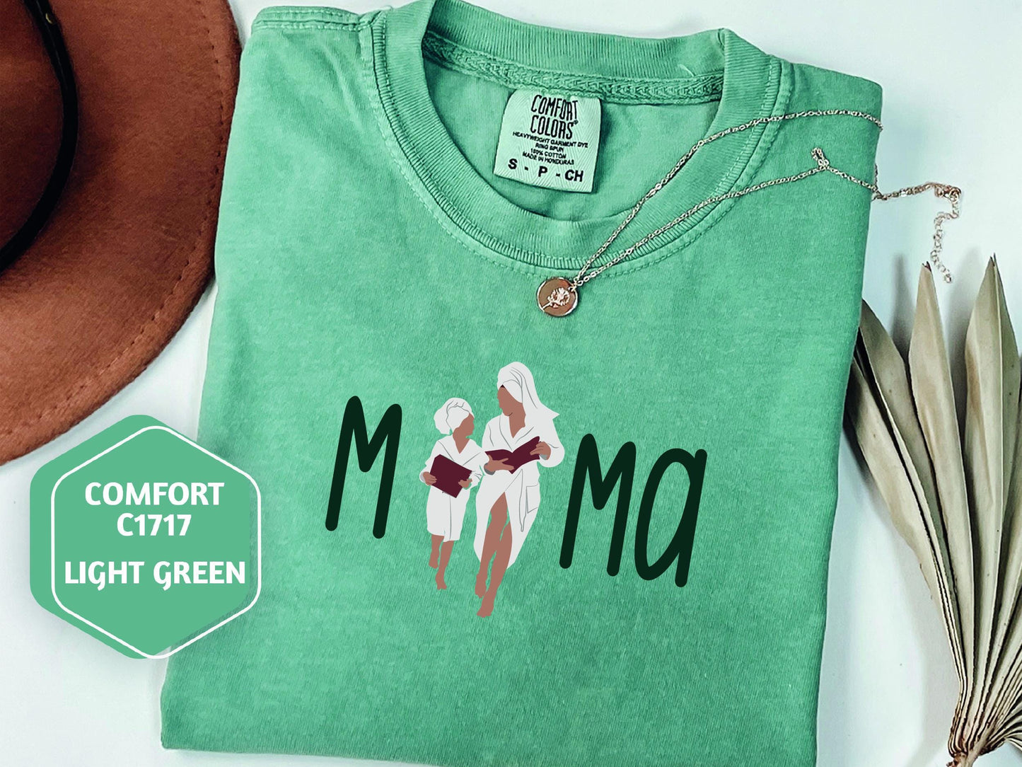 a green shirt with a picture of two women on it