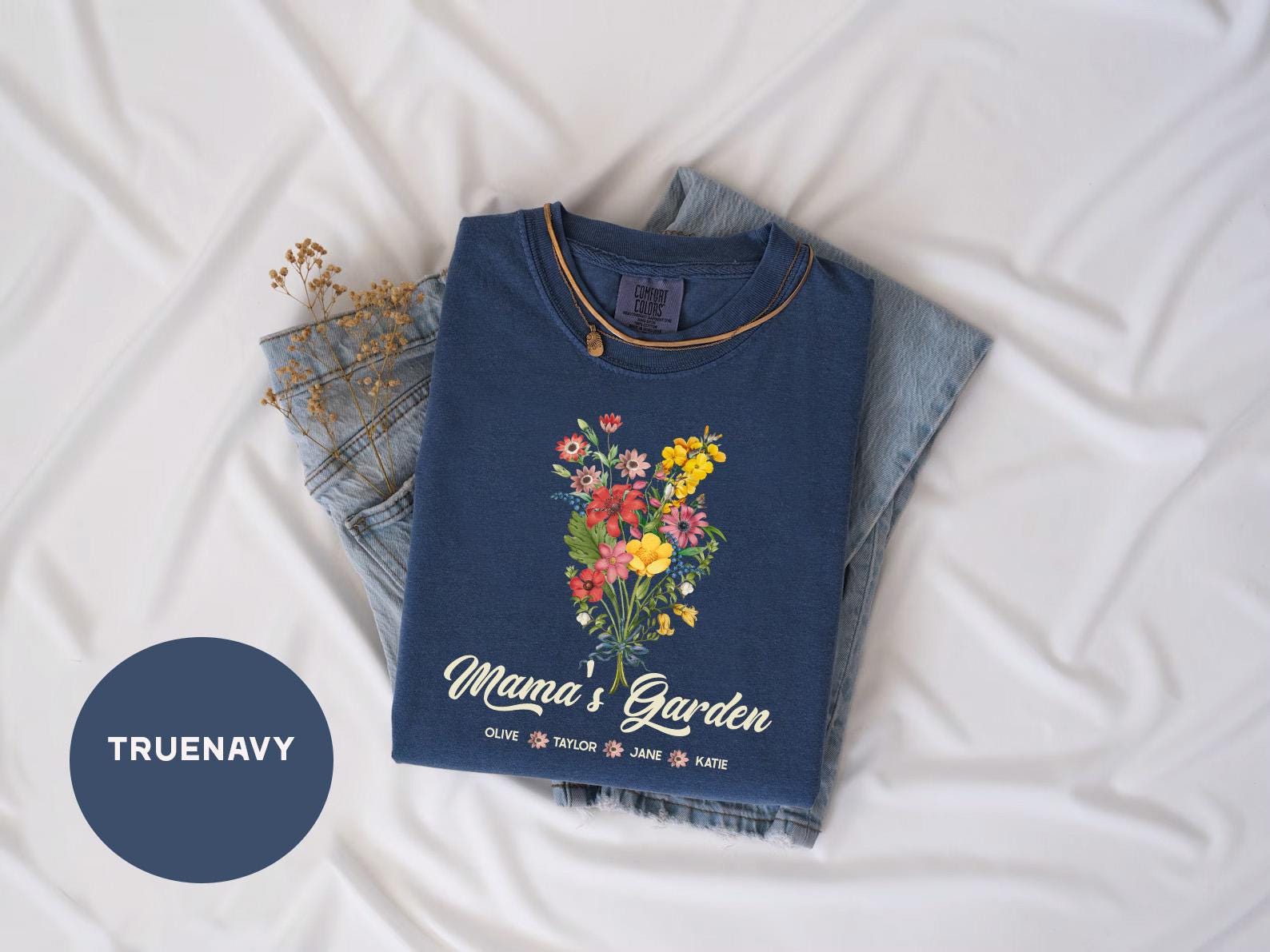 a t - shirt with a bouquet of flowers on it next to a pair of