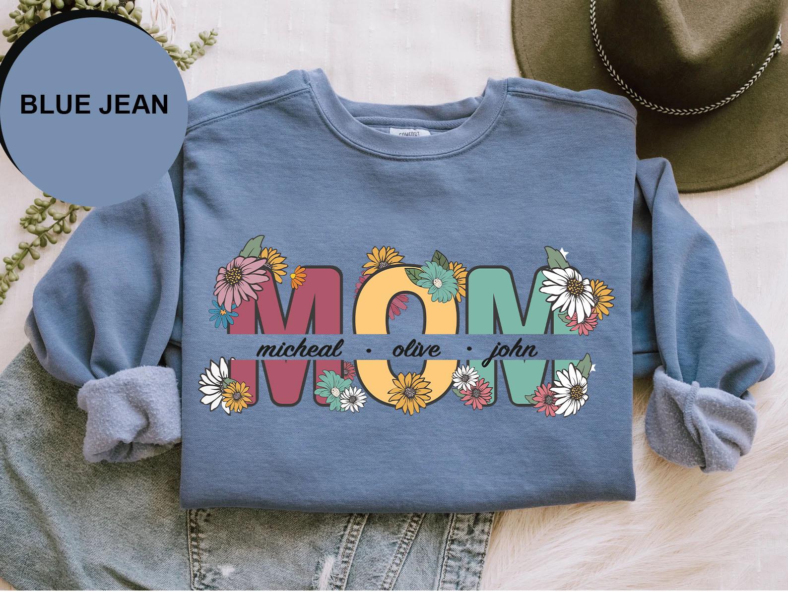 a blue jean shirt with the word mom printed on it