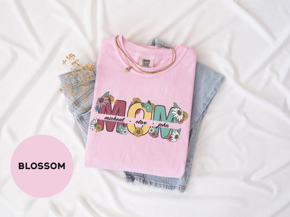 a pink shirt with the word mom on it