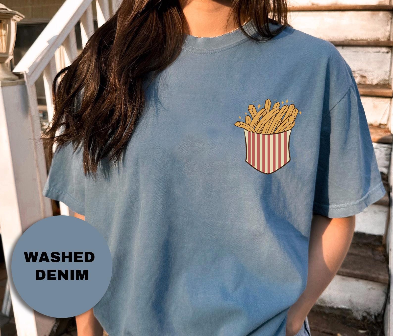 a woman wearing a blue t - shirt with a french fries pocket