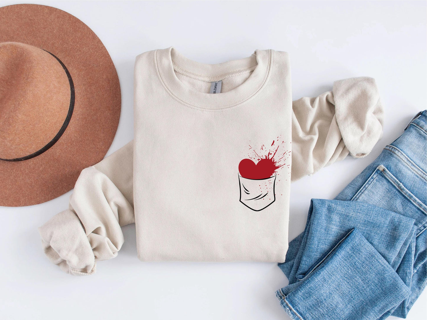 a pair of jeans, a hat, and a t - shirt on a white