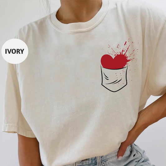a woman wearing a white shirt with a red heart on it