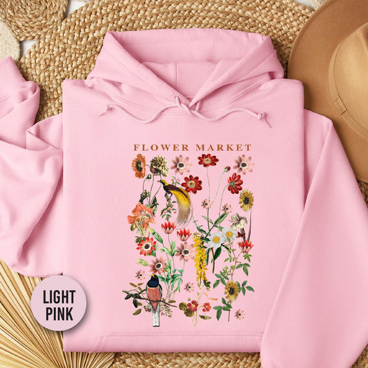 a pink hoodie with a picture of a flower market on it