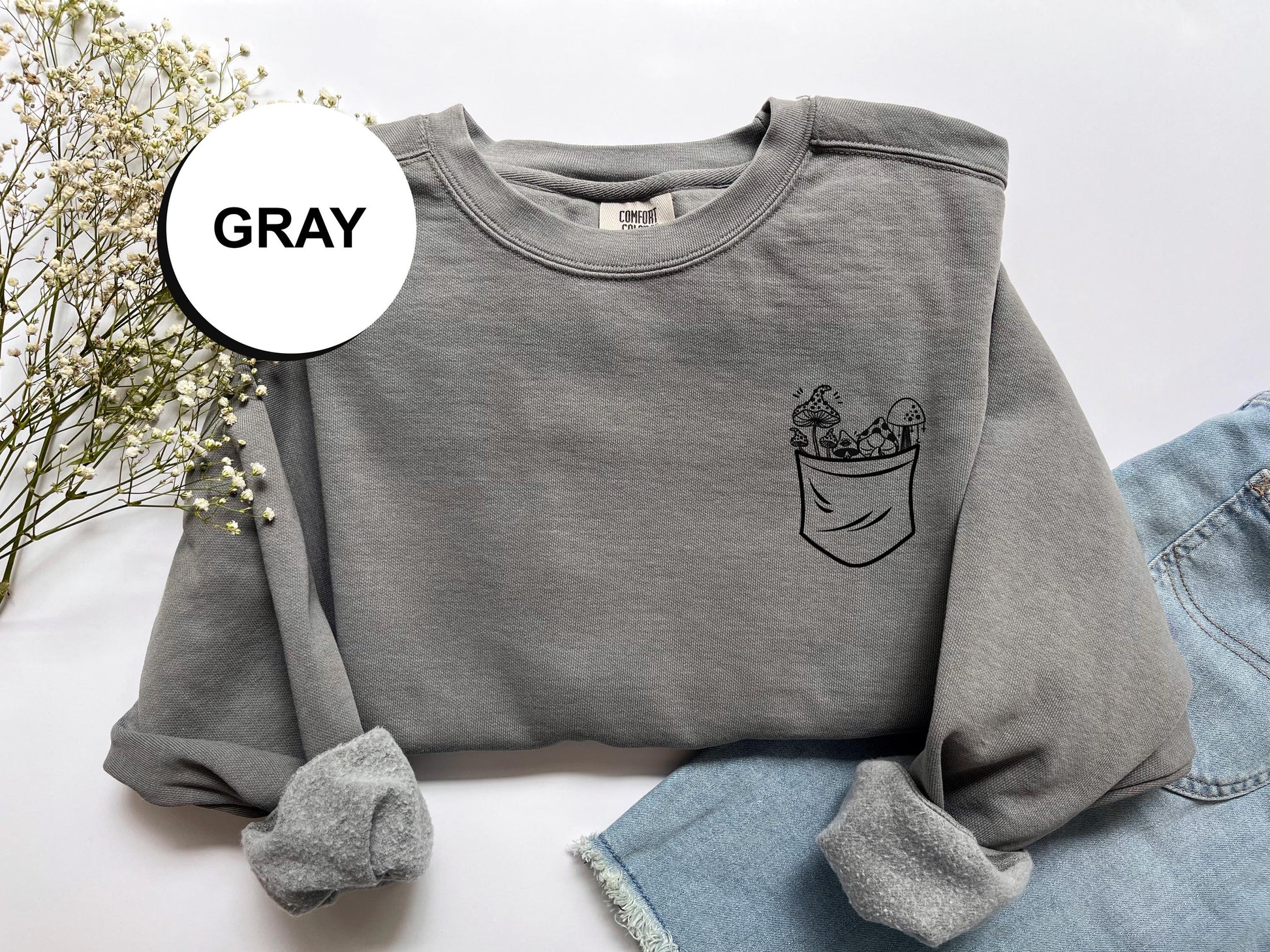 a gray sweatshirt with a pocket on it