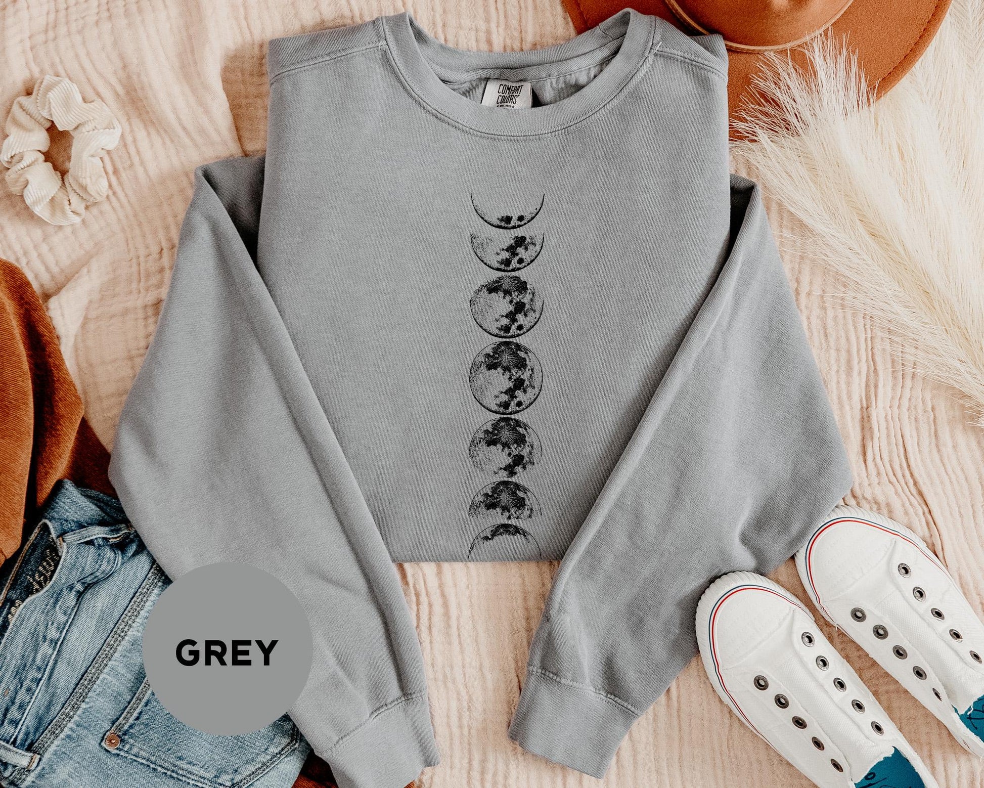 a grey sweatshirt with a graphic of a tree and moon on it
