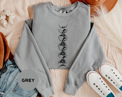a grey sweatshirt with a graphic of a tree and moon on it