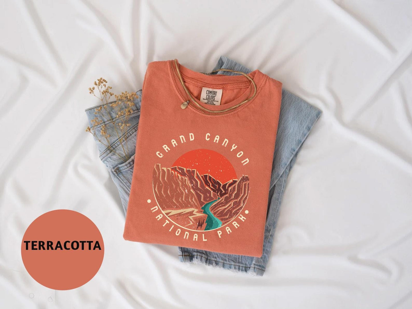 a t - shirt and jeans laying on a bed