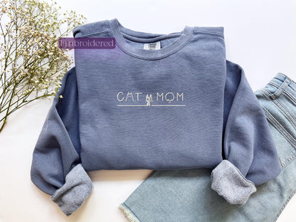 a blue sweatshirt with the word cat mom on it