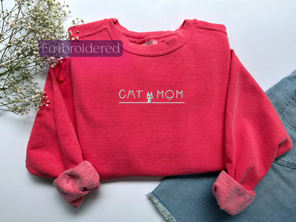 a red shirt with the word cat mom on it