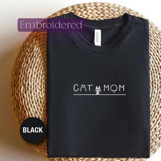 a black t - shirt with the word cat and mom printed on it