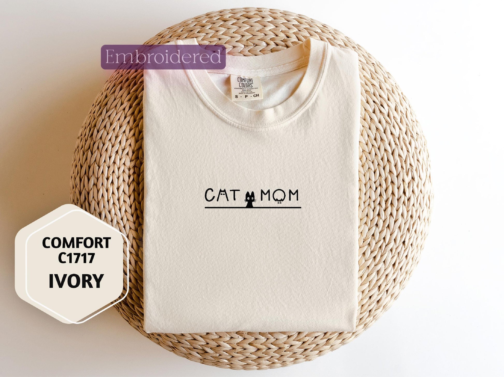 a cat mom t - shirt sitting on top of a wicker basket