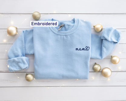 a blue sweater with a name embroidered on it