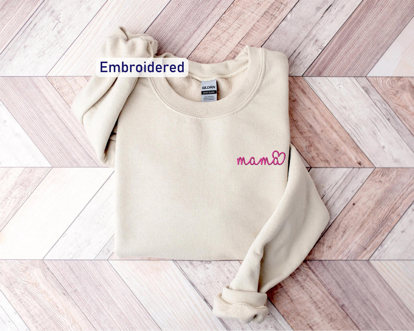 a white sweater with a name embroidered on it