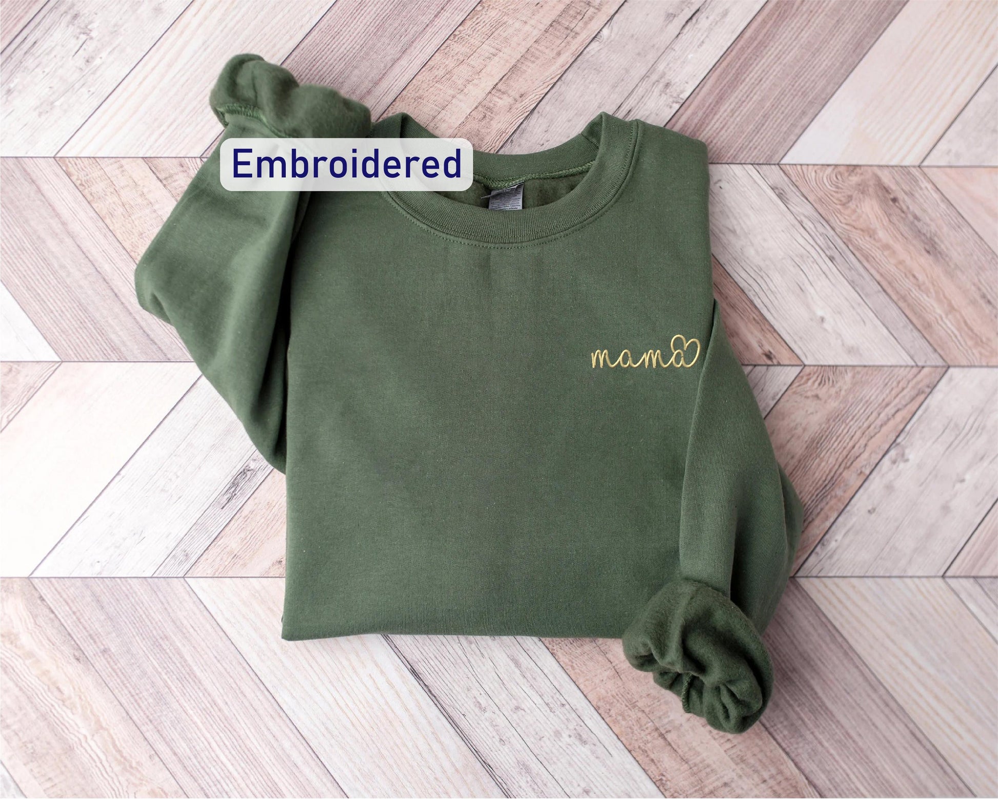 a green sweatshirt with embroidered name on it