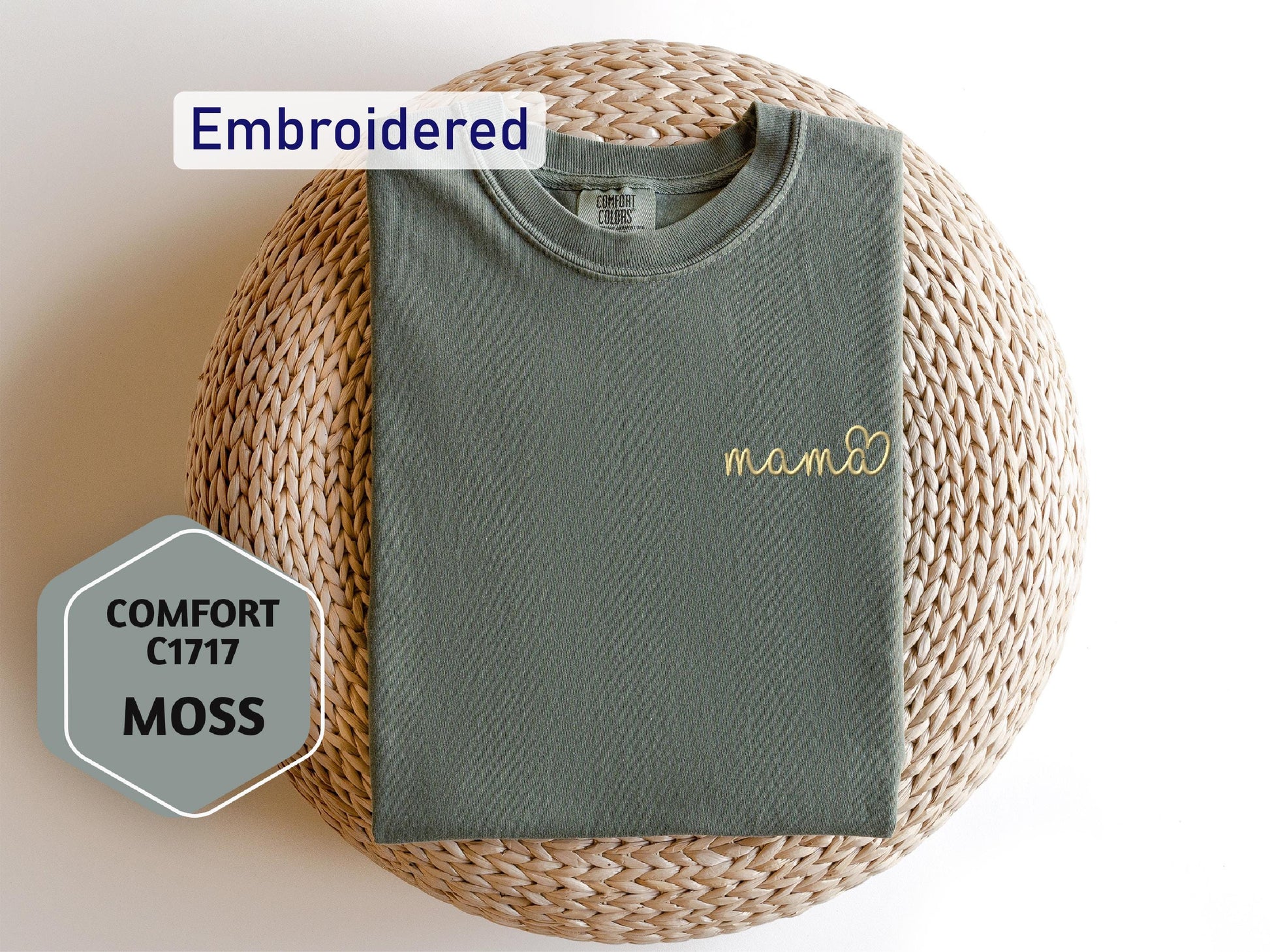 a t - shirt with a name on it sitting on a wicker basket
