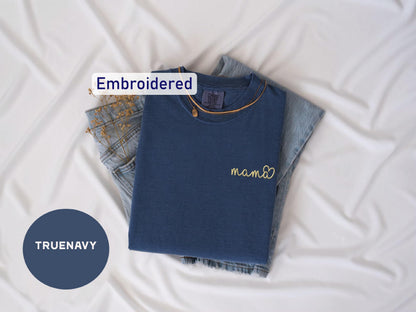 a blue shirt with a name on it next to a pair of jeans