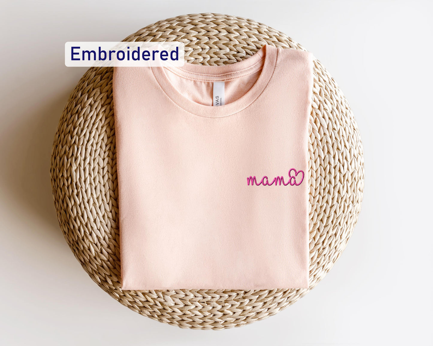 a pink t - shirt with the word embroidered on it