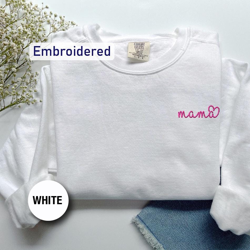 a white shirt with a pink embroidered name on it
