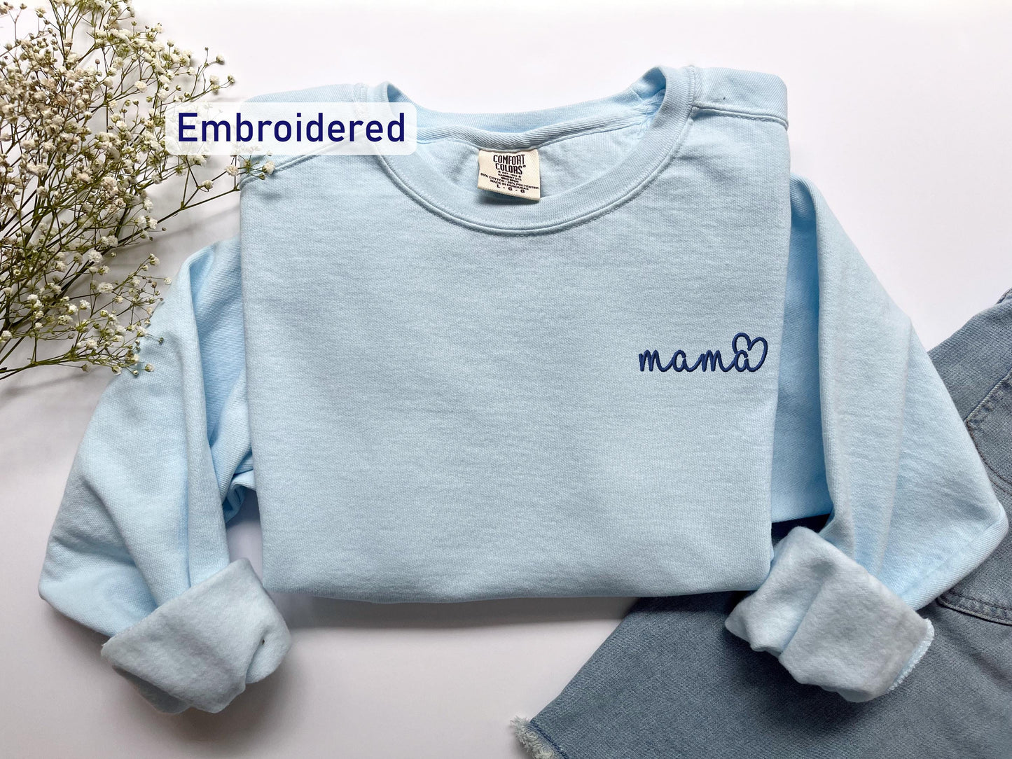 a blue sweater with the word mama written on it