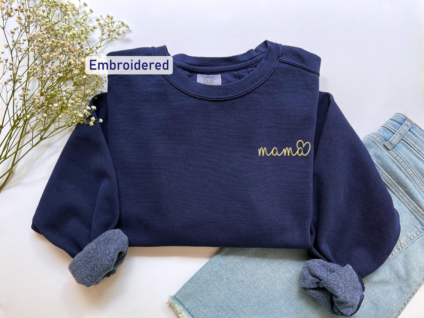 a blue shirt with a name on it and a pair of jeans