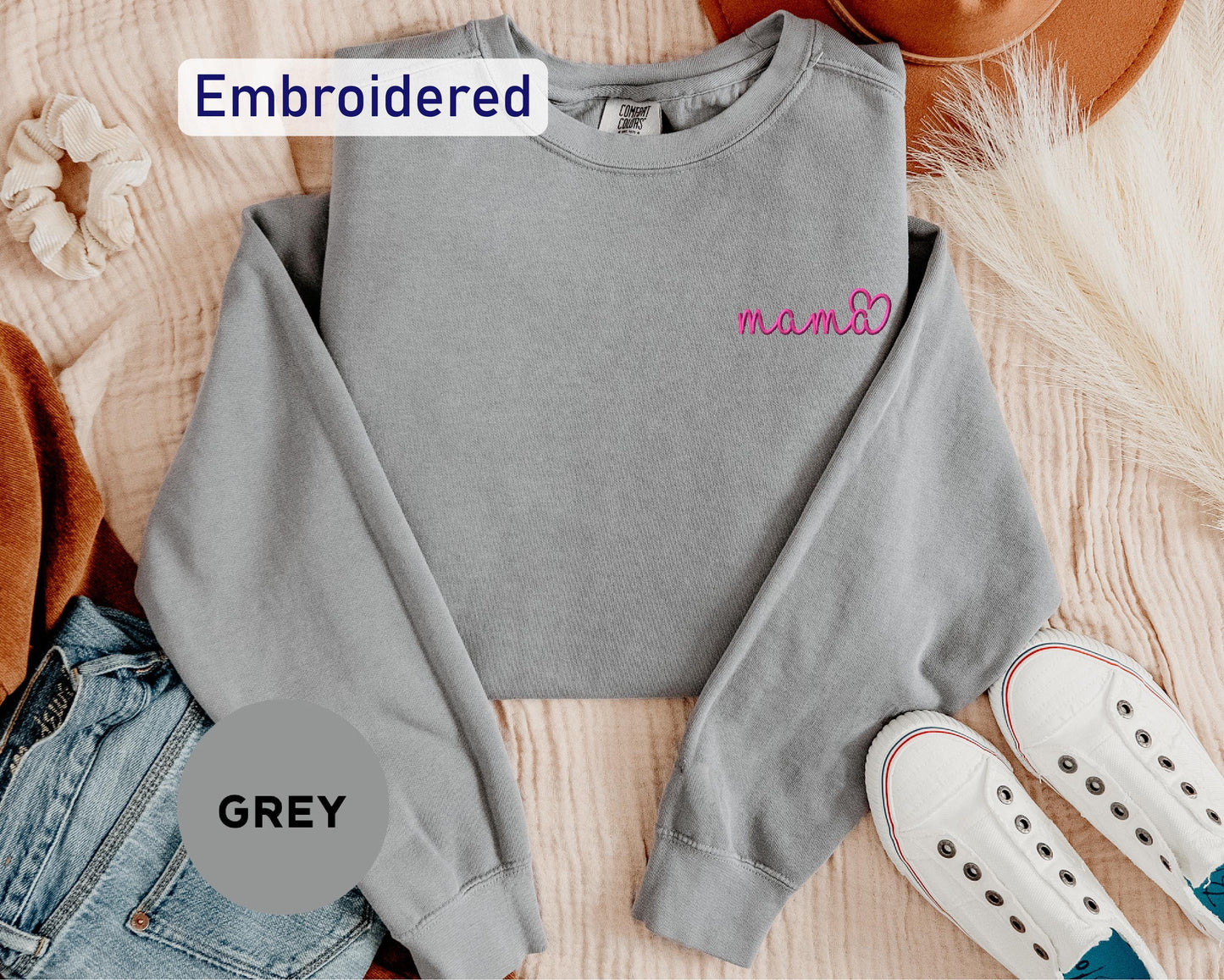 a gray sweatshirt with the word embroidered on it