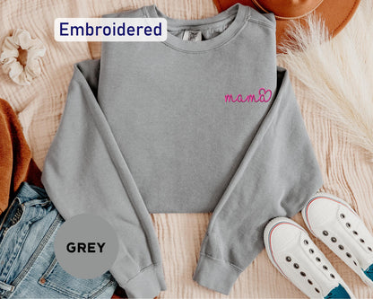 a gray sweatshirt with the word embroidered on it