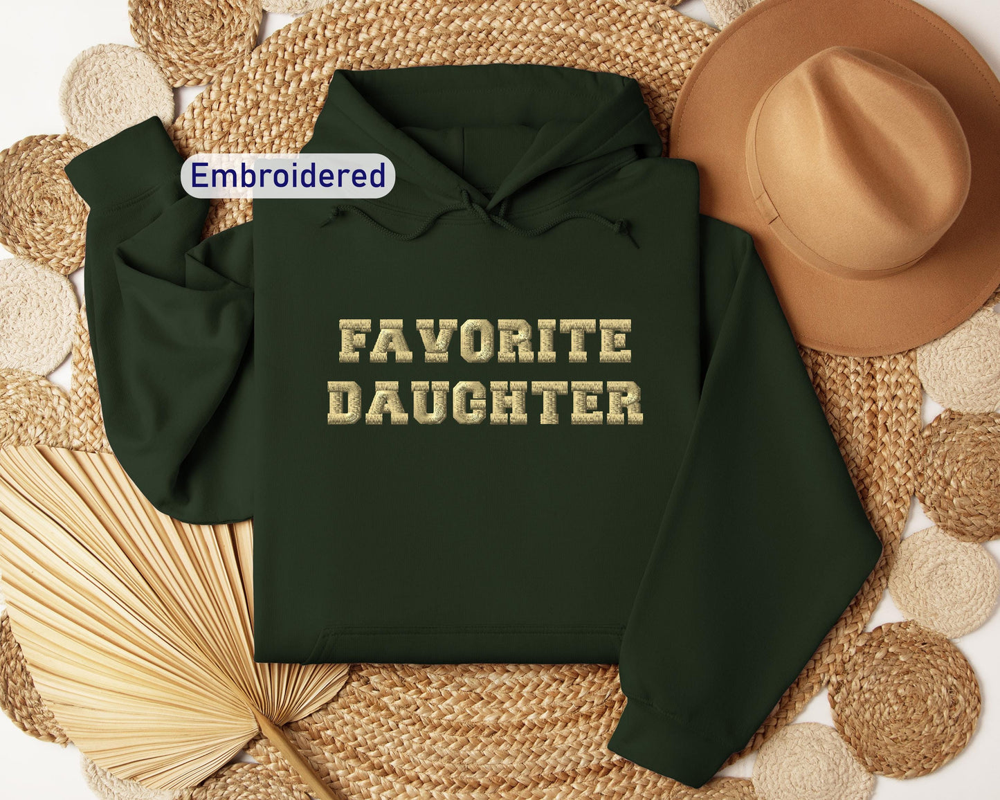 a green hoodie with the words favorite daughter on it