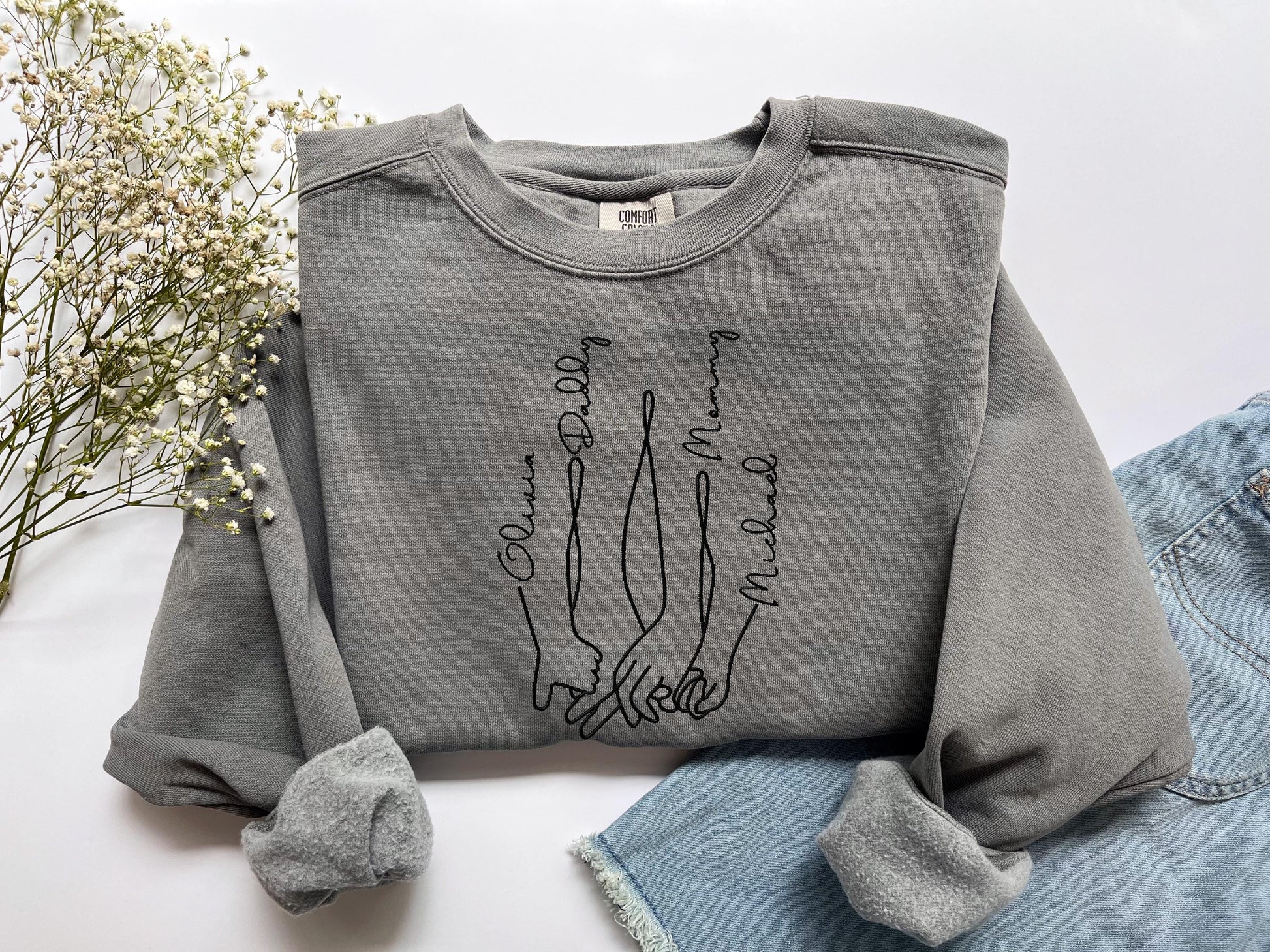 a gray sweatshirt with a drawing on it