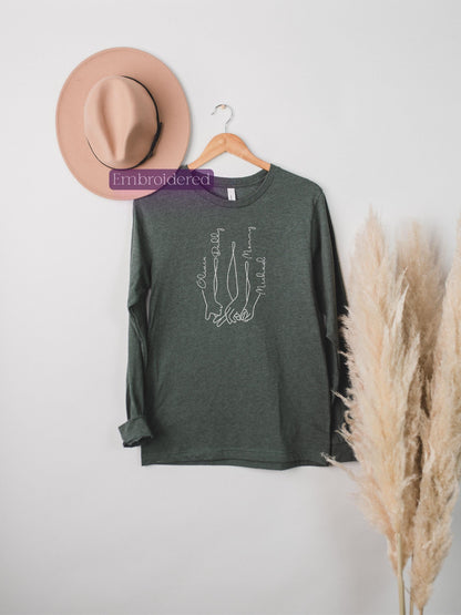 a hat, a t - shirt, and a dried plant on a white wall