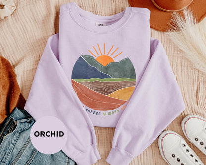 a purple shirt with a mountain scene on it