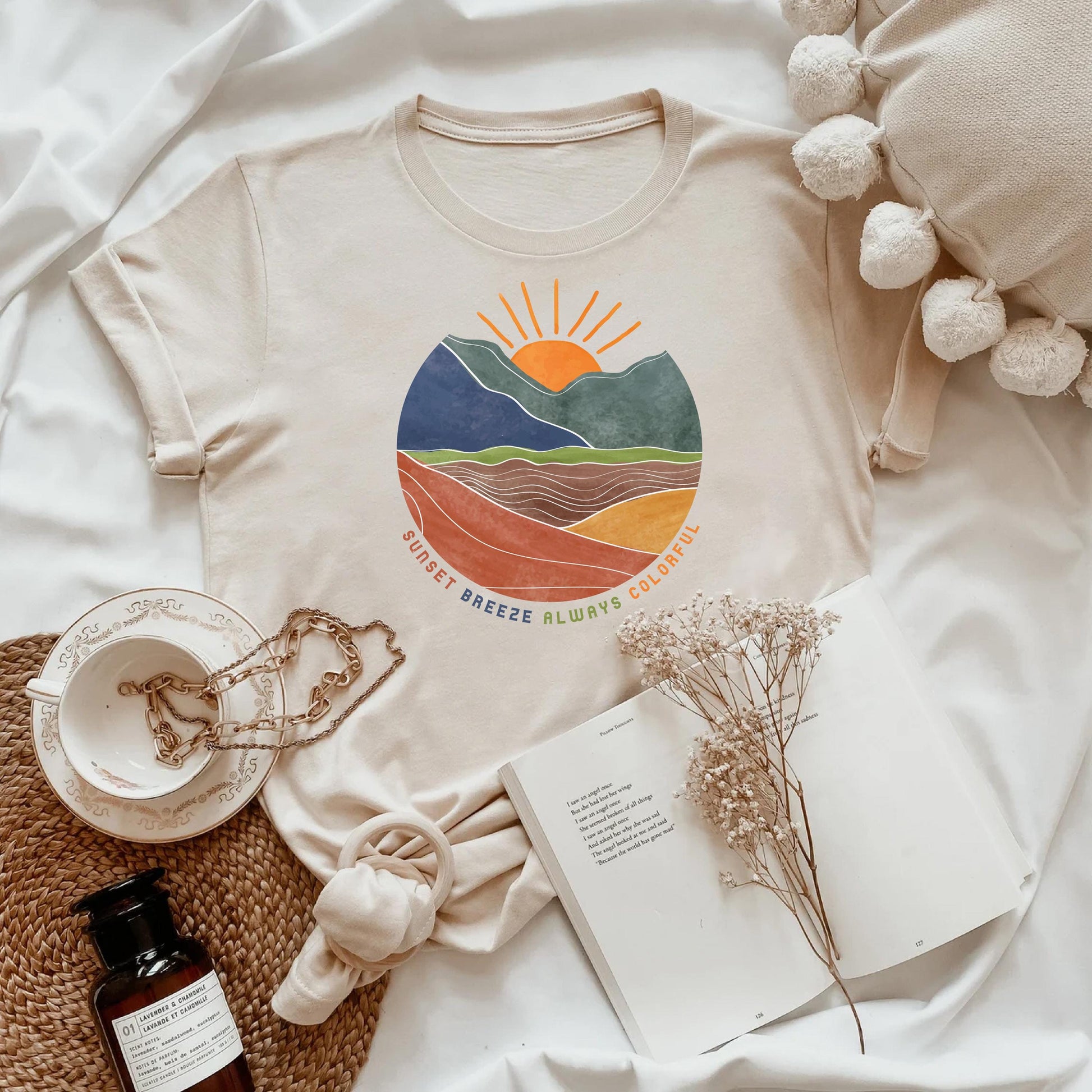 a white t - shirt with a mountain scene on it