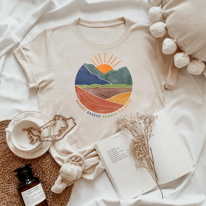 a white t - shirt with a mountain scene on it