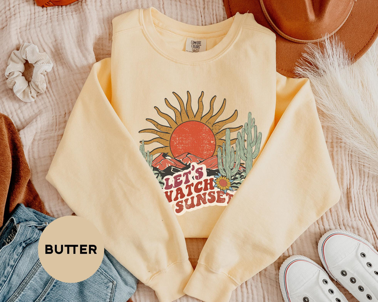 a pair of shoes and a sweater on a bed