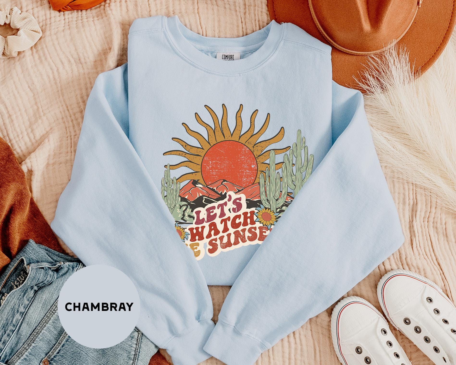 a blue shirt with a picture of a sun on it