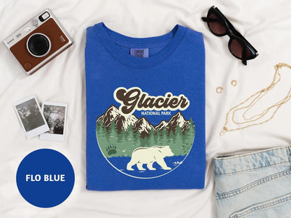a t - shirt with a polar bear on it next to a pair of sunglasses