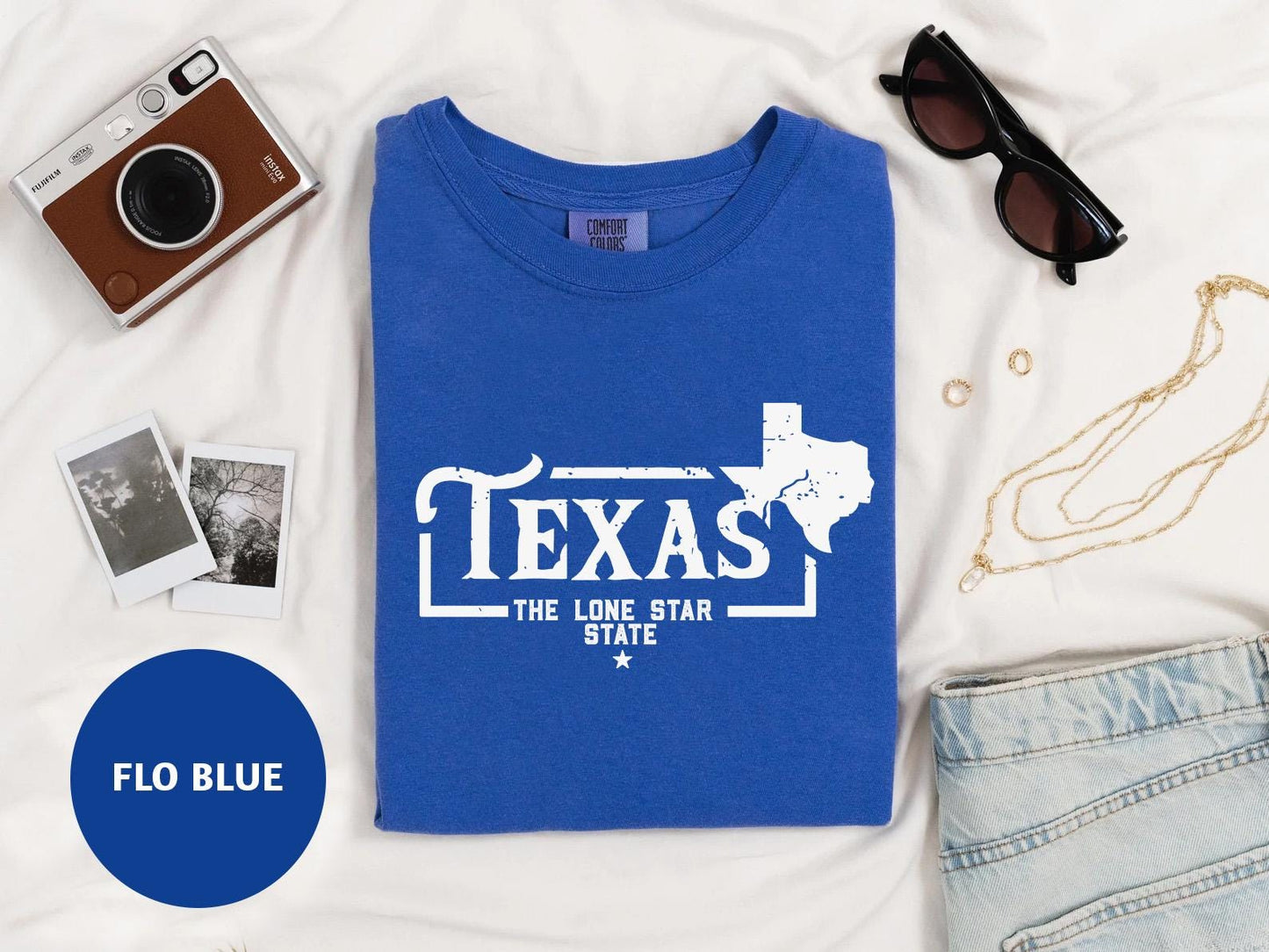 a t - shirt that says texas the lone star state next to a pair of