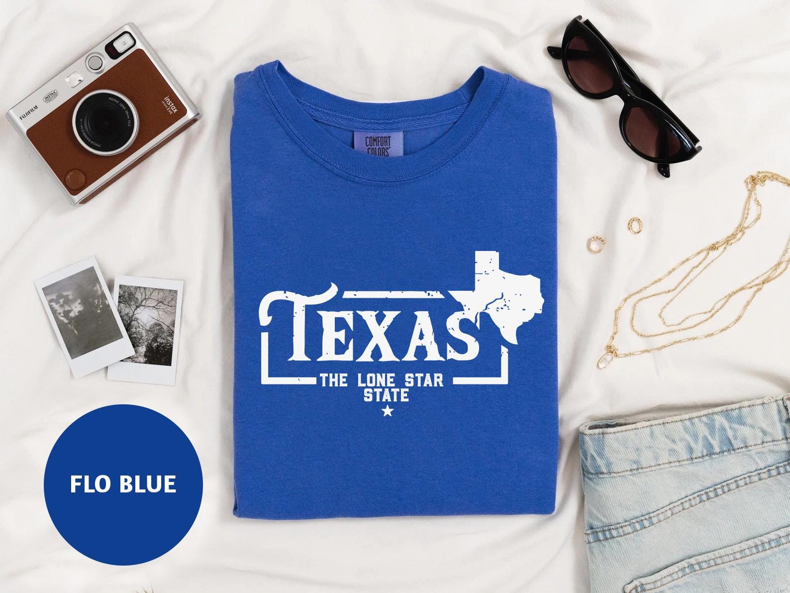 a t - shirt that says texas the lone star state next to a pair of