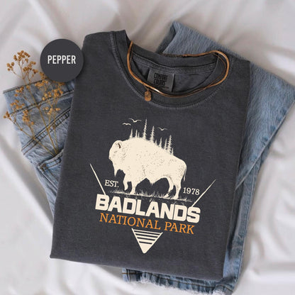 a t - shirt with a buffalo on it sitting on a bed