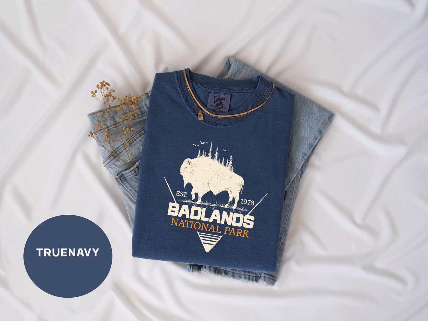 a t - shirt that says badlands next to a pair of jeans