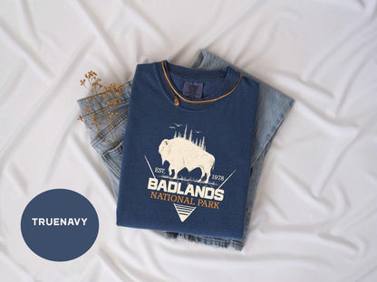 a t - shirt that says badlands next to a pair of jeans