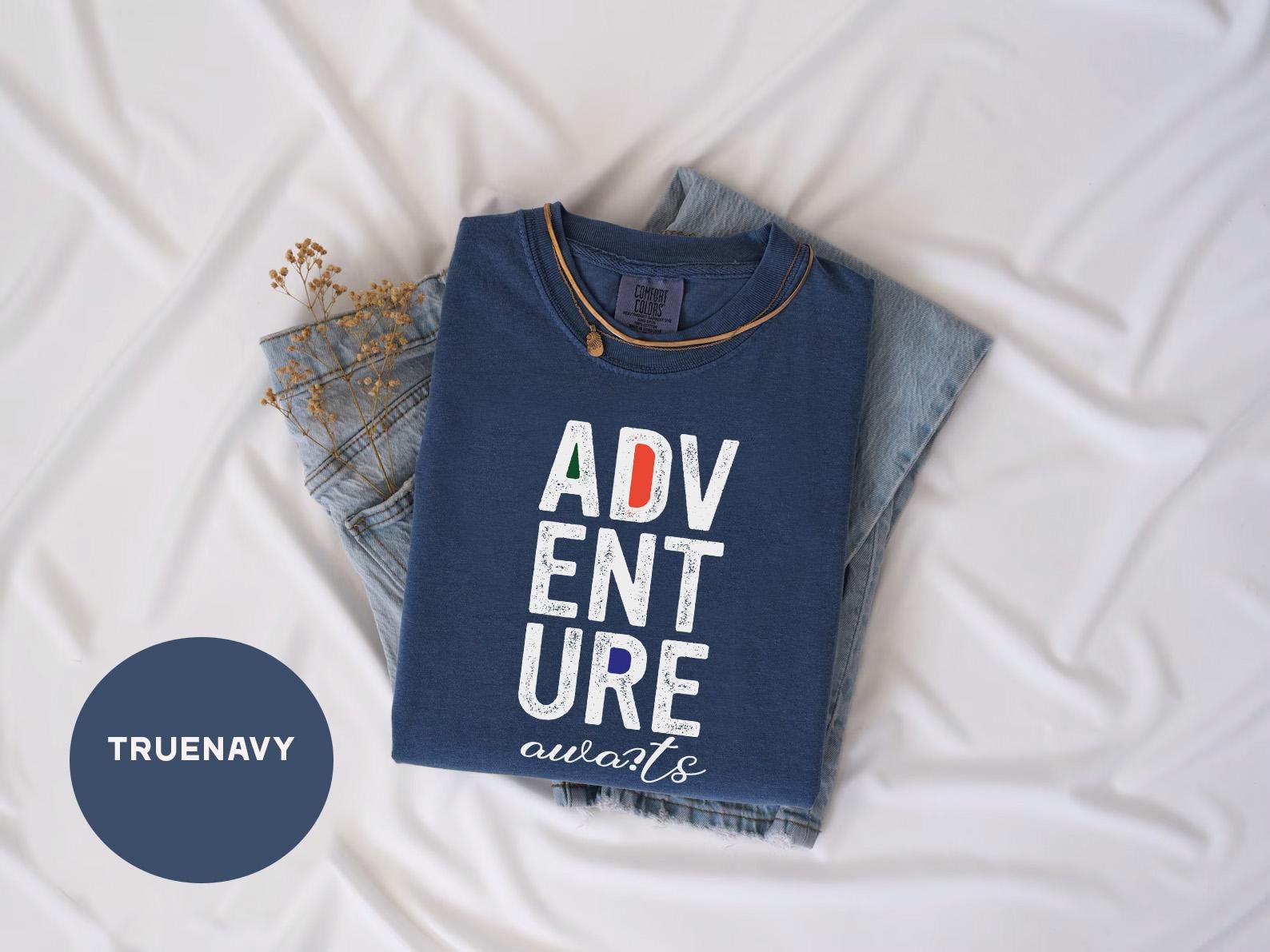a t - shirt that says adv ent sure is next to a pair
