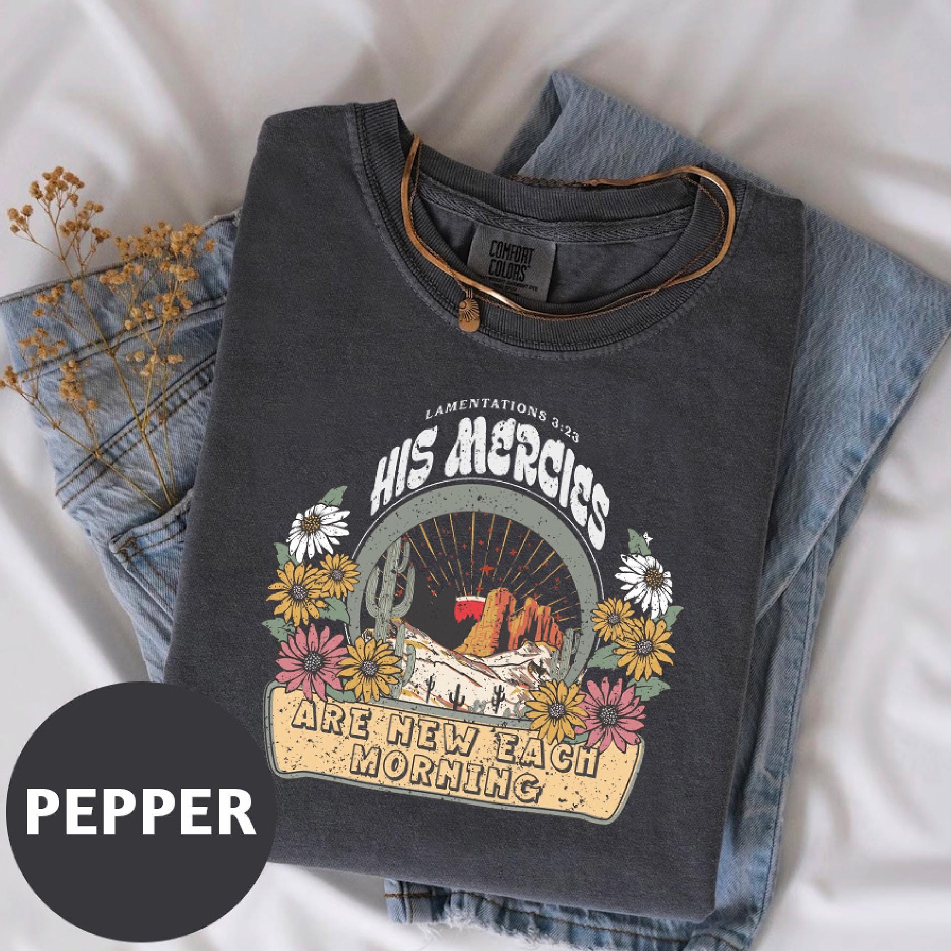 a pair of jeans and a t - shirt on a bed