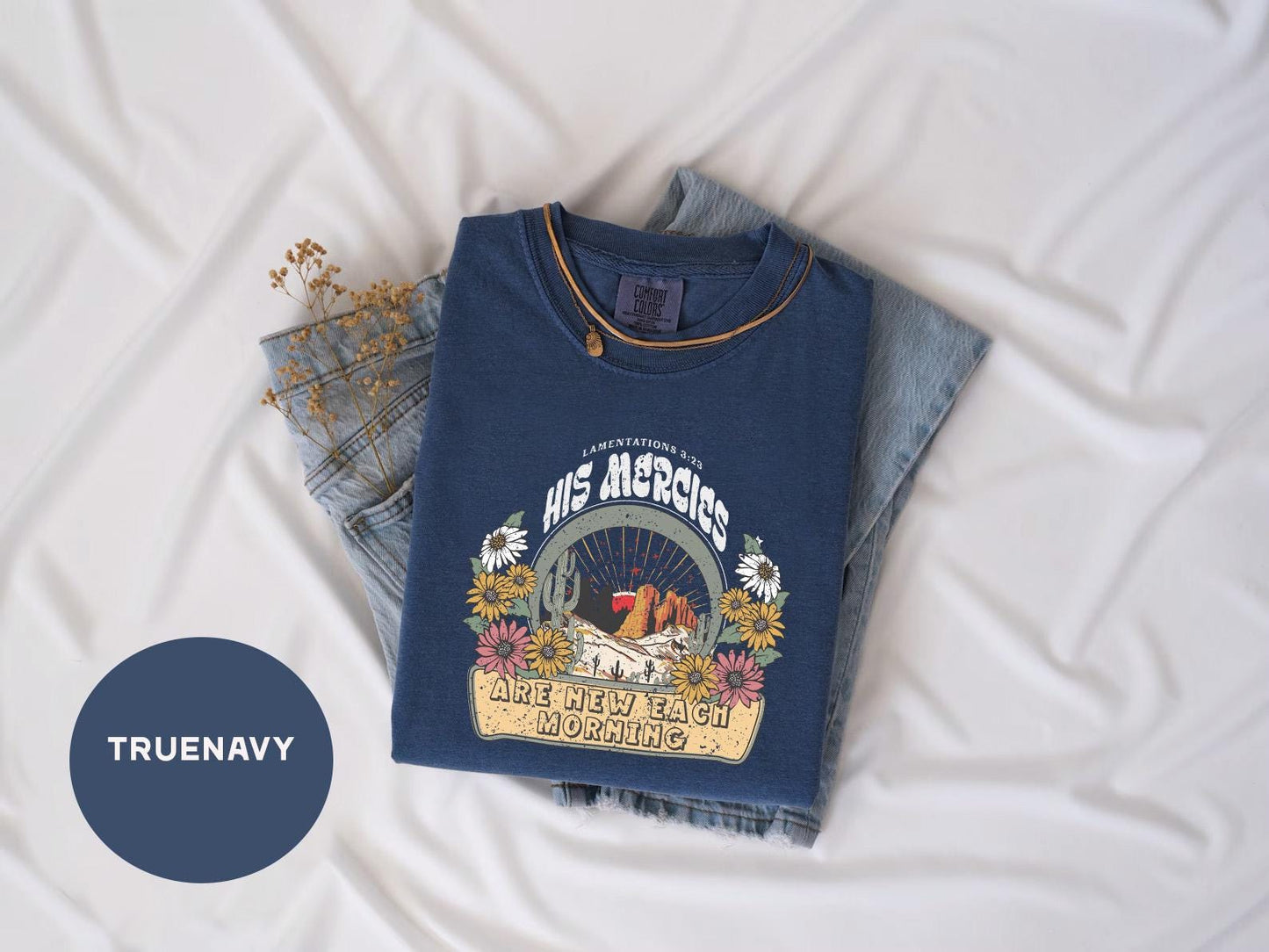 a pair of jeans and a t - shirt on a bed