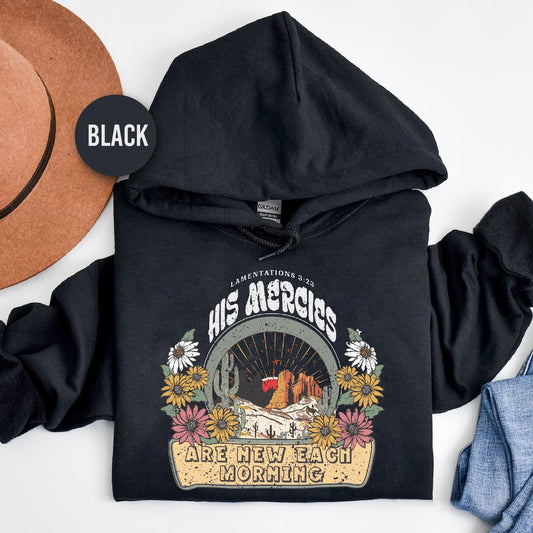 a black hoodie with a cowboy hat next to it